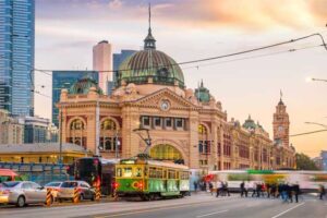 Melbourne's Flinders Street train station location from the steps of St Paul's Cathedral watching trams, cars and people pass with the frenetic energy of a busy city. Business Electricity Prices started here and knows how time poor business owners can be, so we help you to reduce your energy costs