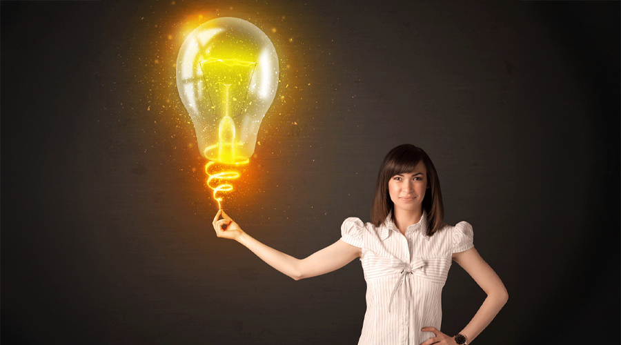 Woman holding a light bulb depicting Best Business Electricity Prices